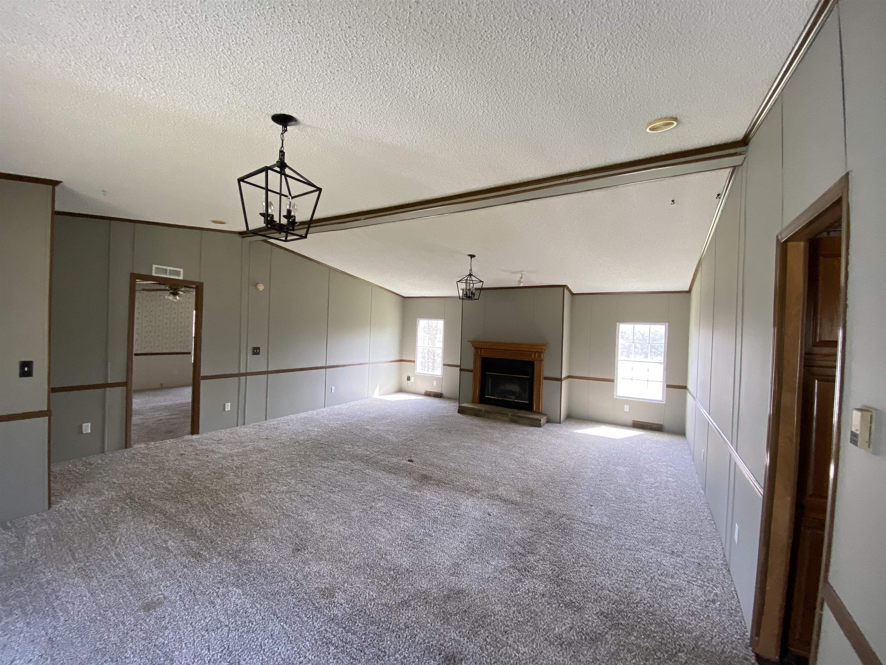 3737 Williams Switch Road Henning, TN 38041 - Photo 9 of 17 a view of empty room with fireplace and window