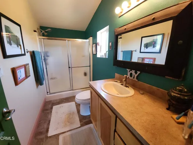 a bathroom with a sink toilet and mirror