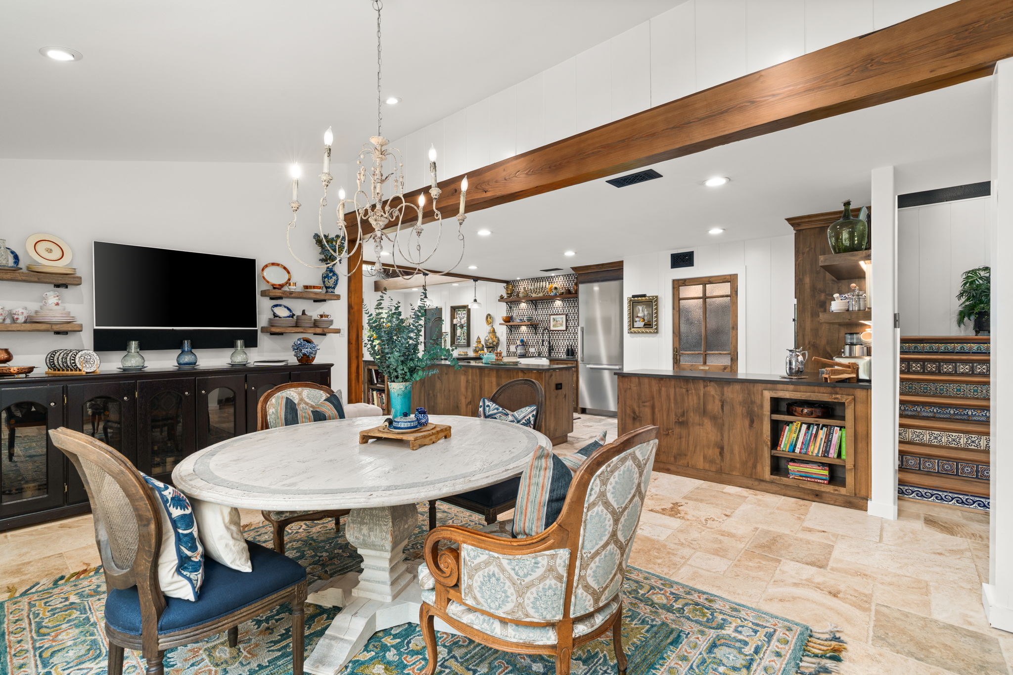 11941 Overlook Pass Austin, TX 78738 - Photo 14 of 40 Open-concept living space with travertine tile flooring, a decorative chandelier, and exposed wood beam accents