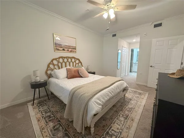 a bedroom with a bed and a chandelier