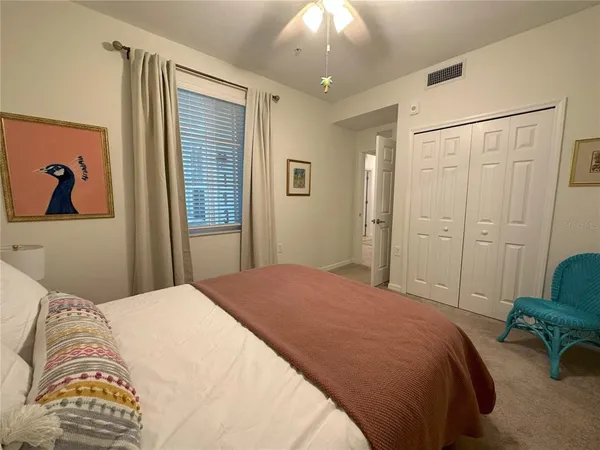a living room with couch and a floor to ceiling window