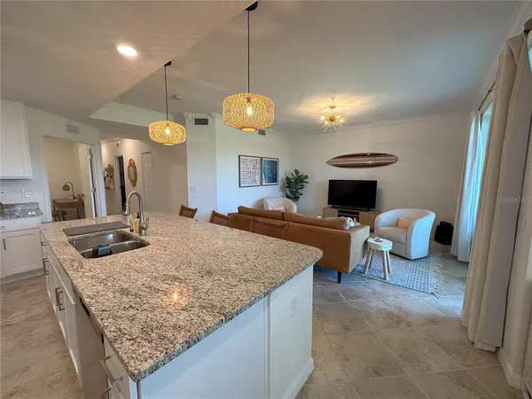 a kitchen with stainless steel appliances kitchen island granite countertop a refrigerator and cabinets
