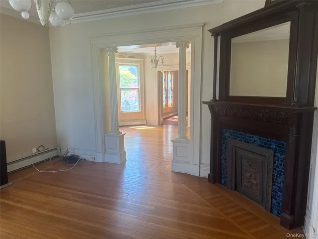 a view of a livingroom with wooden floor and a fireplace