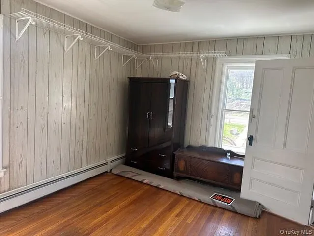 a room with a window and wooden floor