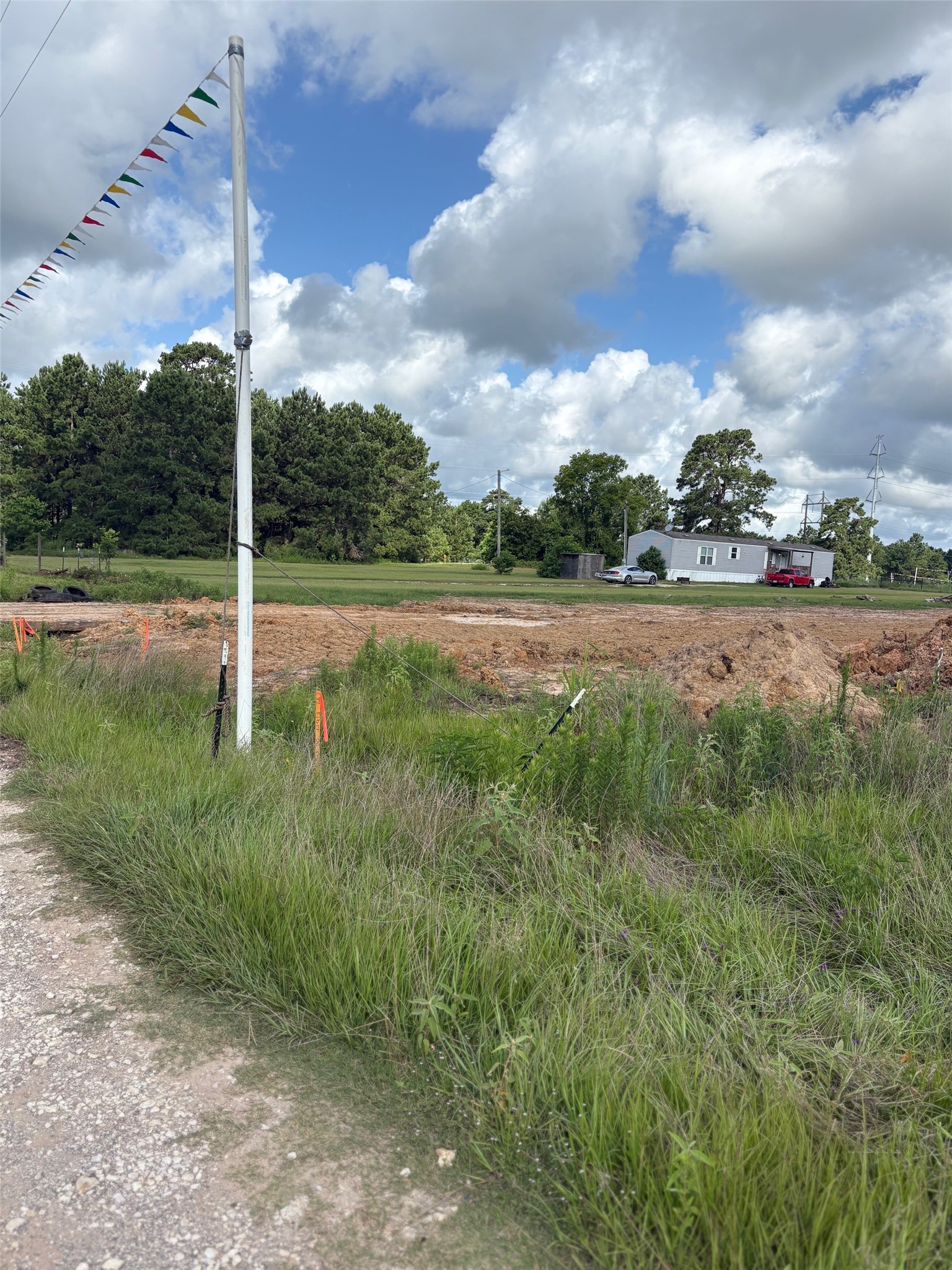 148 A Rogers Road New Waverly, TX 77358 - Photo 15 of 19 This shows the a portion of the property where a pipeline was recently buried. In the distance you can see the seller occupied home that's listed with the property.