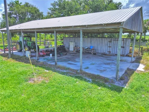 a backyard of a house with table and chairs