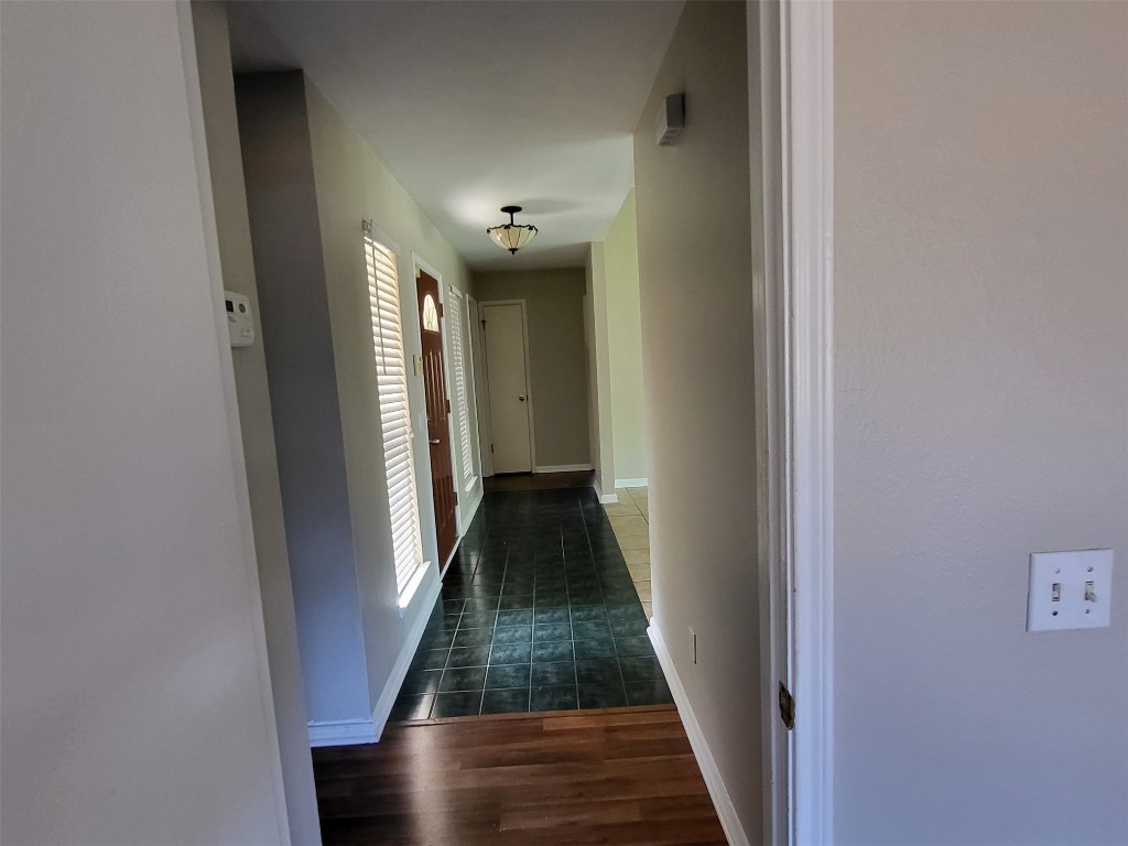 512 Maplecreek Drive Leander, TX 78641 - Photo 7 of 13 a view of a hallway with wooden floor and staircase