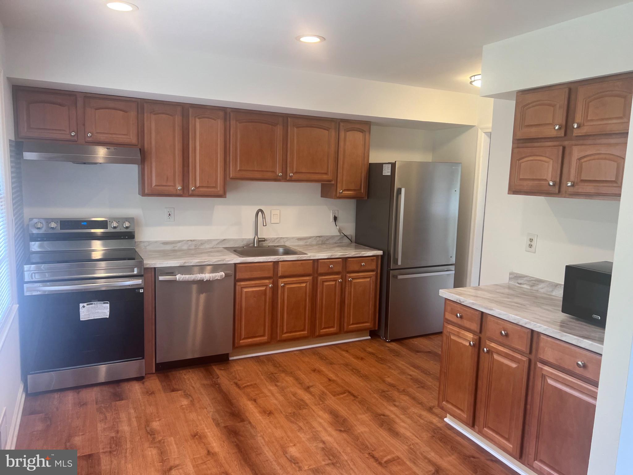 13235 Sturbridge Road Woodbridge, VA 22192 - Photo 21 of 53 Modern kitchen with warm wood accents.