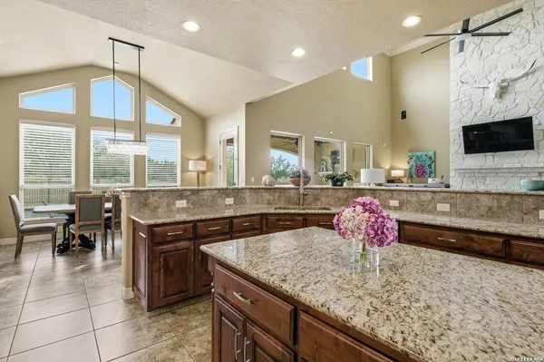 a kitchen with a stove a sink and a wooden cabinets