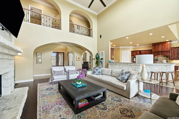 a living room with furniture a rug and kitchen view