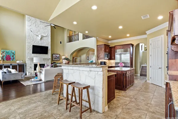 a kitchen with kitchen island granite countertop a stove and a sink