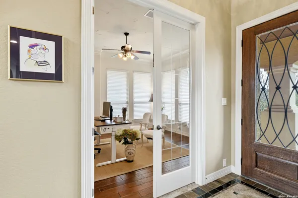 a view of a hallway with workspace and living room