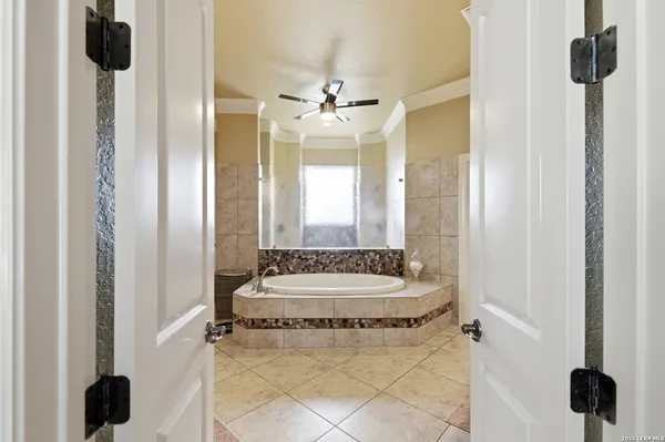 a bathroom with a tub sink and mirror