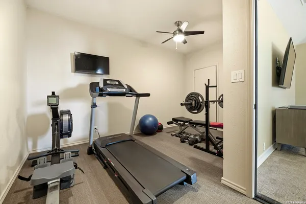 a room with gym equipment and a flat screen tv