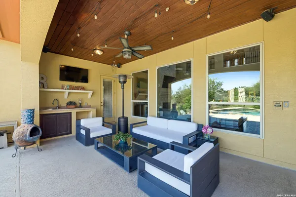 a outdoor space with patio the couches and a flat screen tv