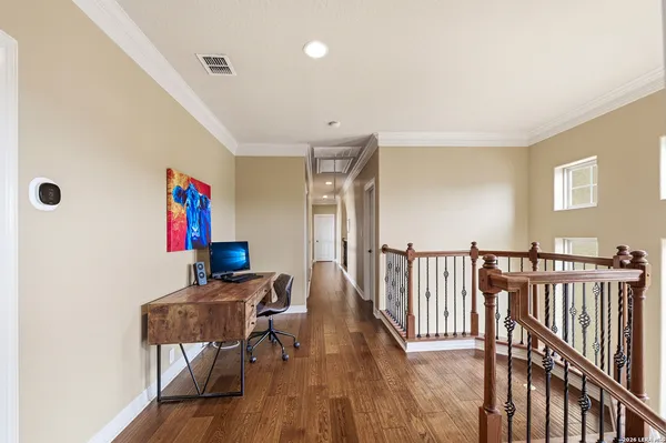 a workspace with furniture wooden floor and window