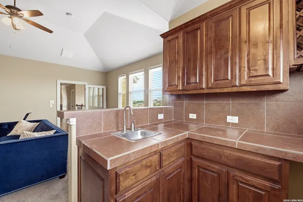 a kitchen with a sink cabinets and wooden floor
