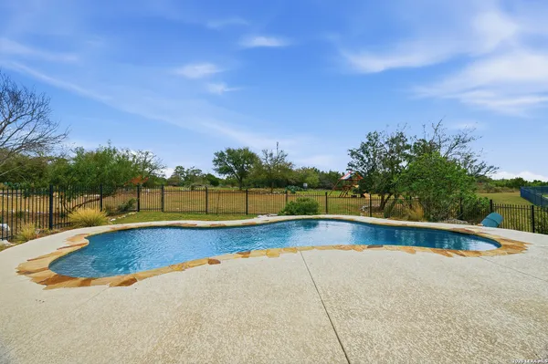 a view of a swimming pool and a yard