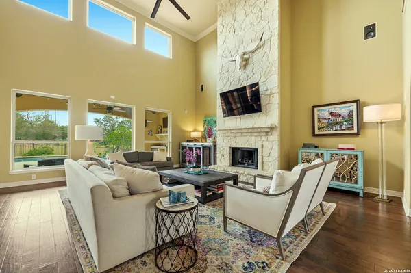 a living room with fireplace furniture and a flat screen tv