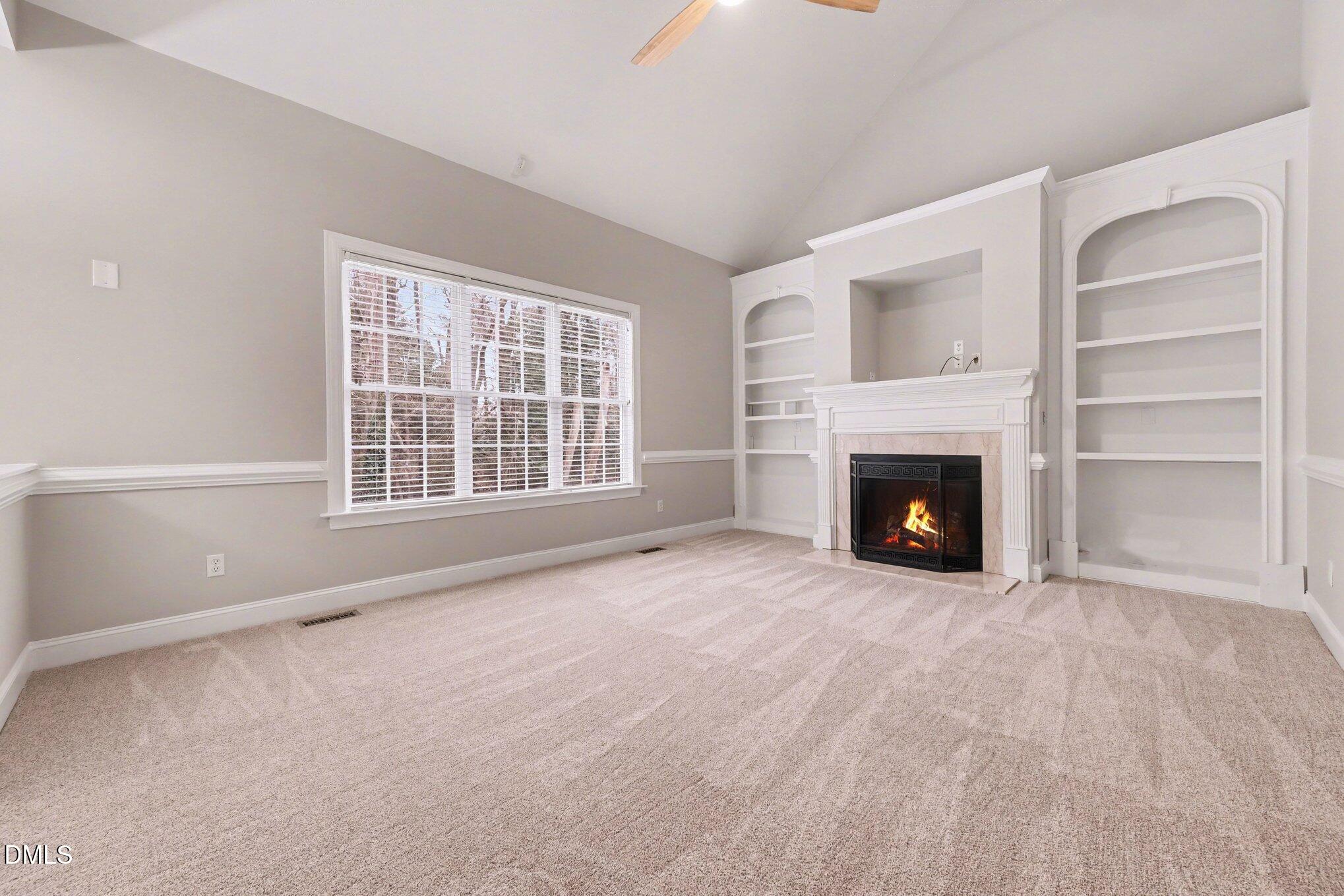 4613 Cherrybark Lane Raleigh, NC 27616 - Photo 3 of 27 a view of an empty room with a fireplace and a window