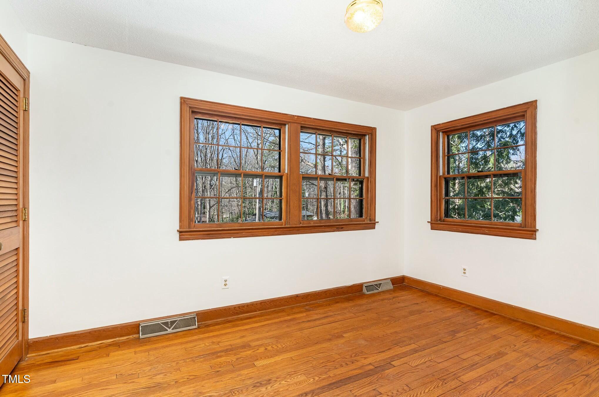 6600 Clinton Place Raleigh, NC 27607 - Photo 19 of 35 a view of an empty room with wooden floor and a window
