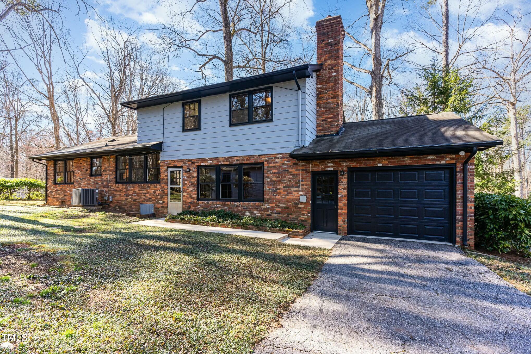 6600 Clinton Place Raleigh, NC 27607 - Photo 25 of 35 a front view of a house with a yard and garage