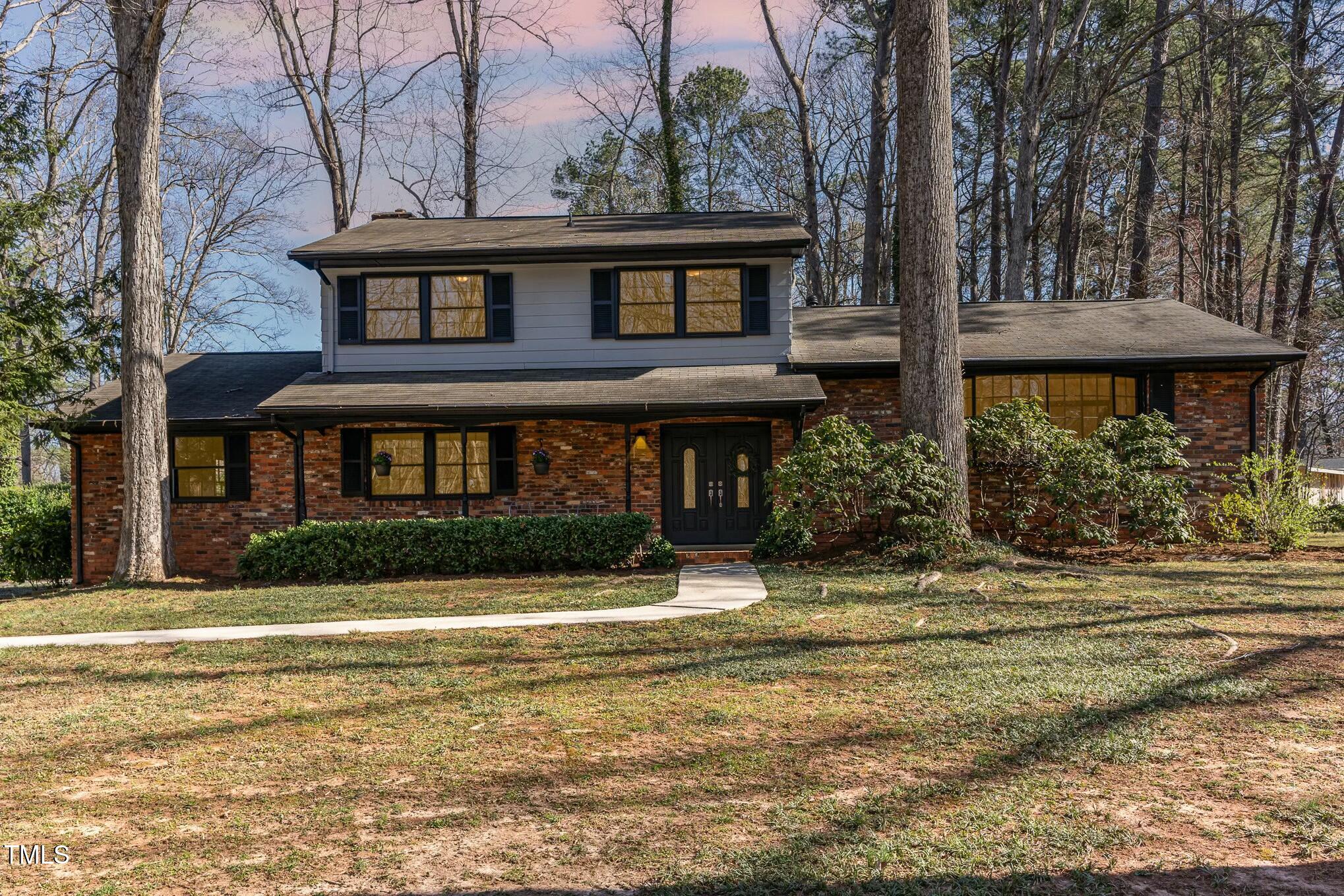 6600 Clinton Place Raleigh, NC 27607 - Photo 26 of 35 a front view of a house with a yard