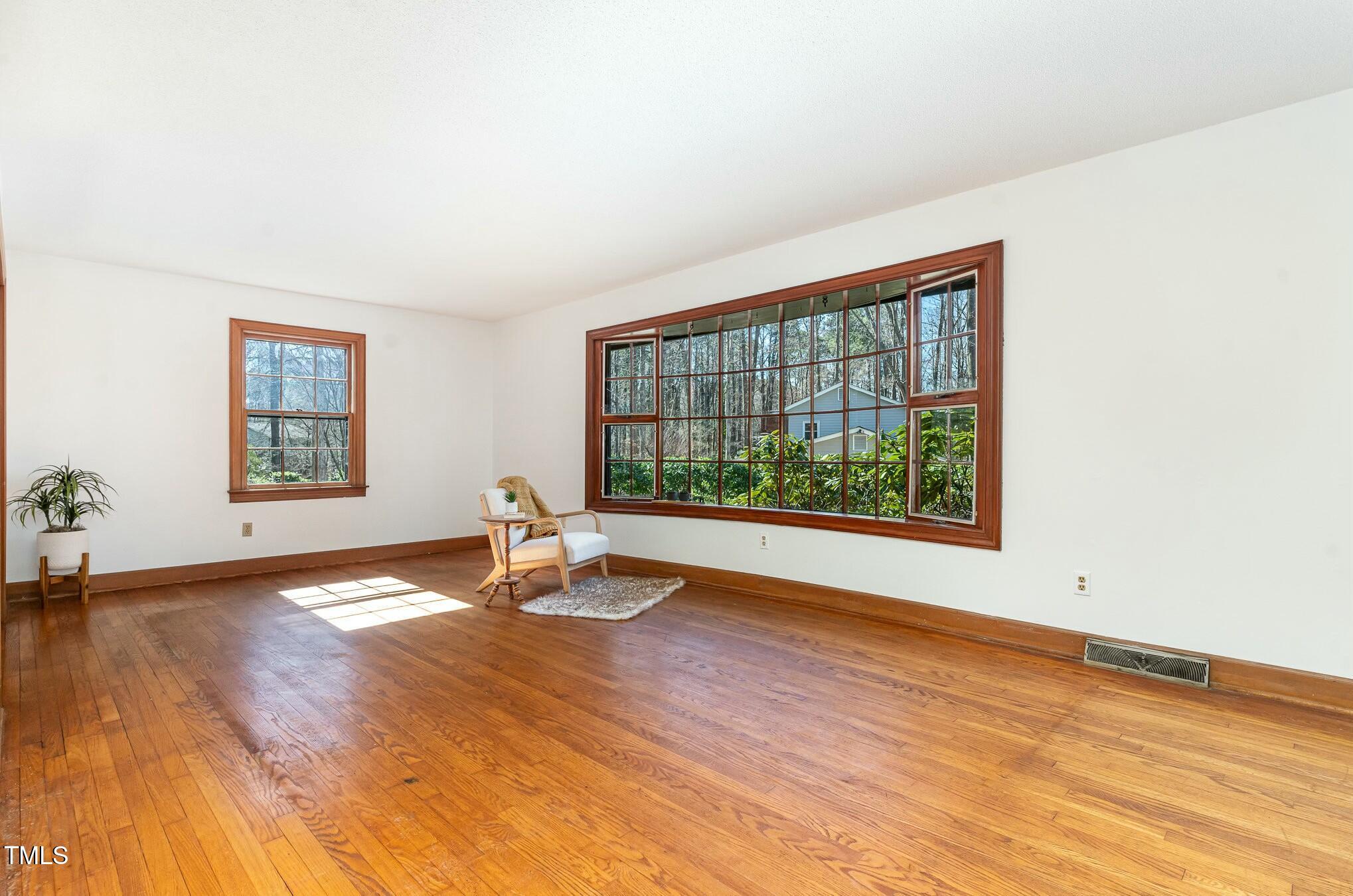 6600 Clinton Place Raleigh, NC 27607 - Photo 7 of 35 a view of empty room with wooden floor and fan
