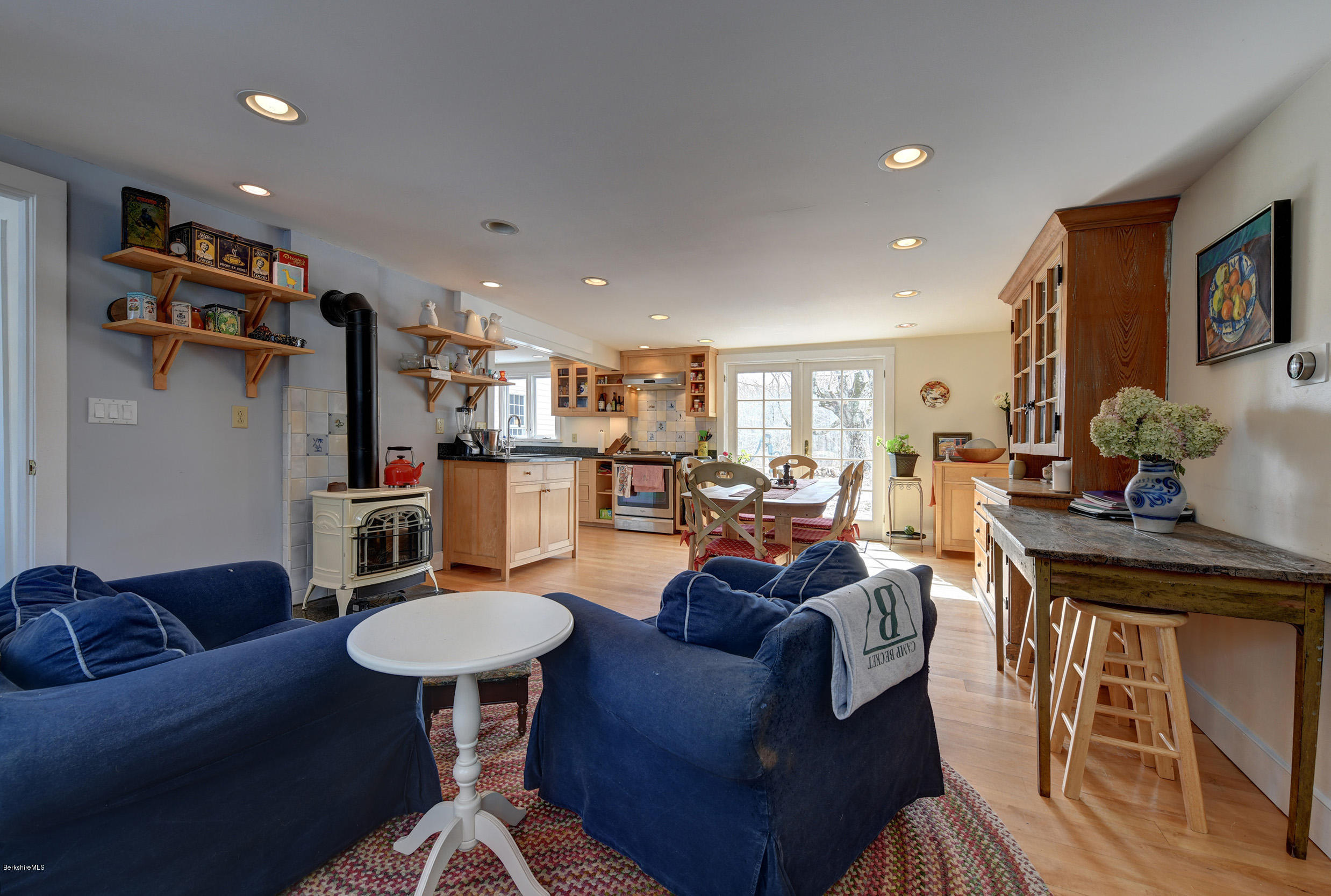 1377 Fred Snow Road Becket, MA 01223 - Photo 15 of 34 a living room with furniture and a dining table with wooden floor