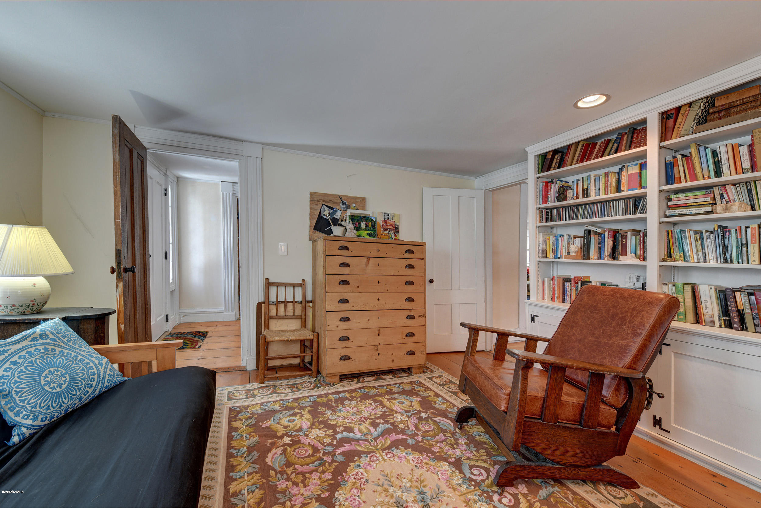 1377 Fred Snow Road Becket, MA 01223 - Photo 17 of 34 a living room with furniture and a book shelf