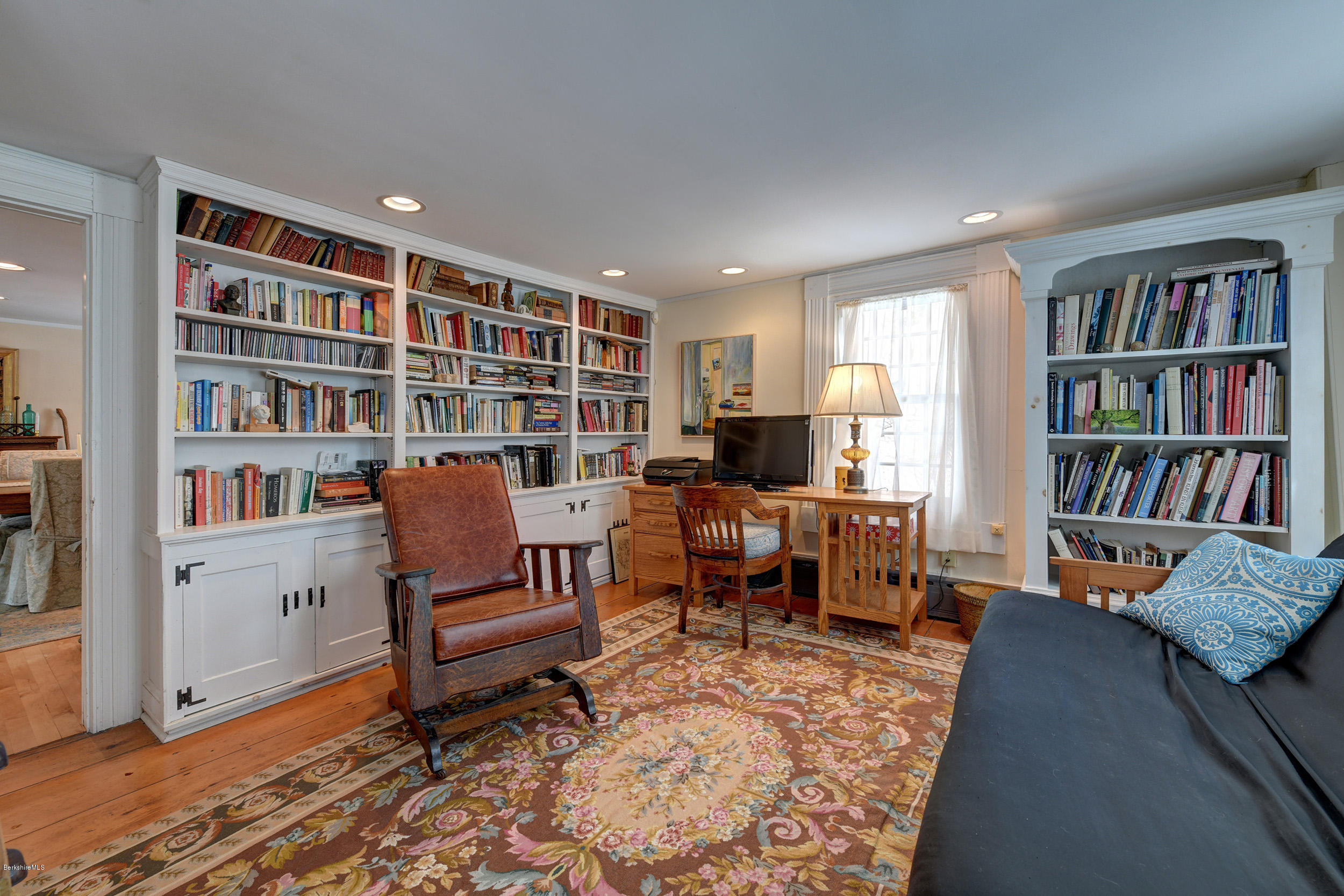 1377 Fred Snow Road Becket, MA 01223 - Photo 18 of 34 a living room with furniture and a book shelf