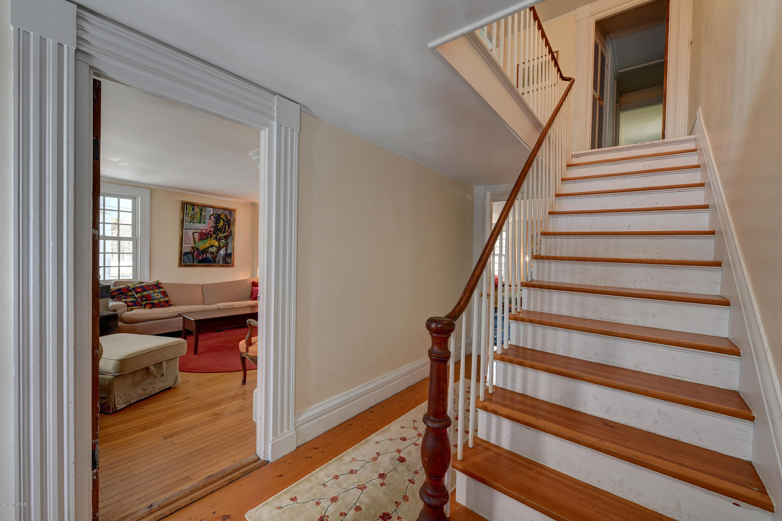 1377 Fred Snow Road Becket, MA 01223 - Photo 20 of 34 a view of a hallway to a livingroom with wooden floor and furniture