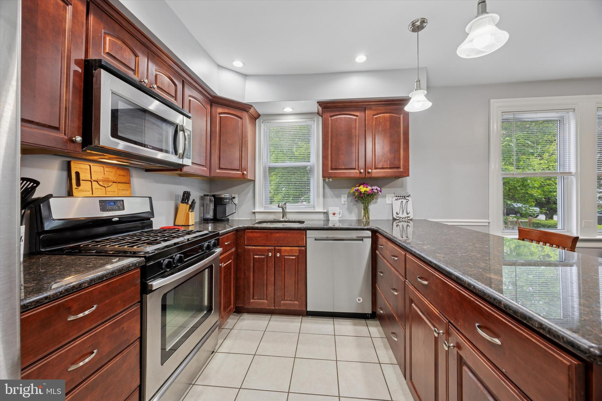245 Sagamore Road Havertown, PA 19083 - Photo 11 of 31 a kitchen with stainless steel appliances granite countertop a stove a sink and a microwave