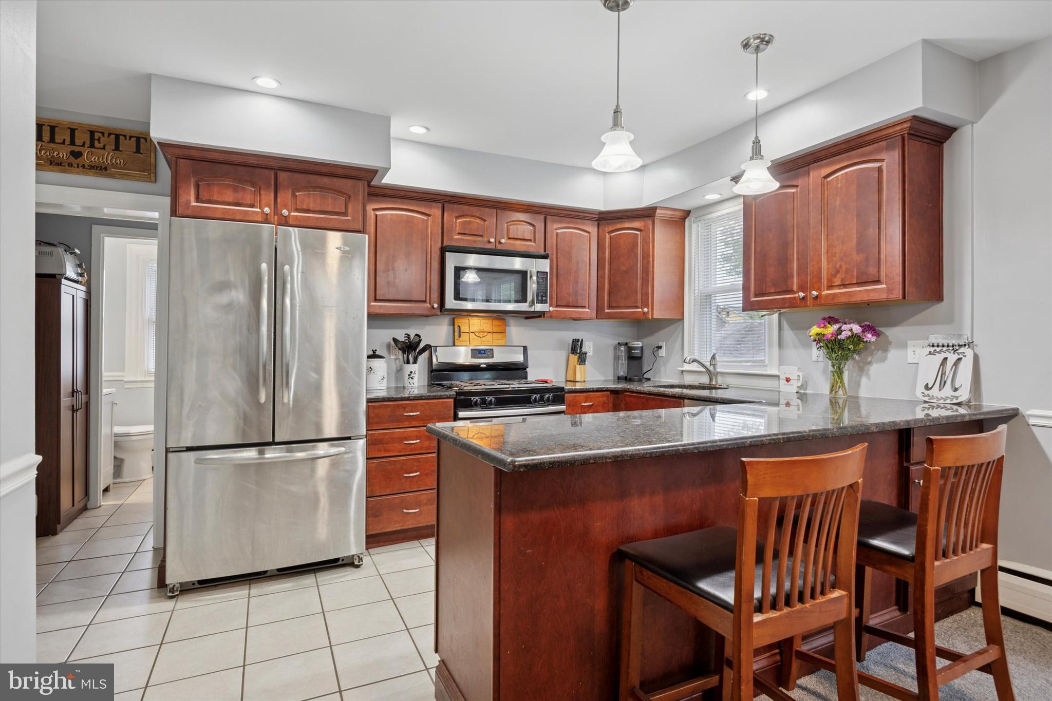 245 Sagamore Road Havertown, PA 19083 - Photo 10 of 31 a kitchen with stainless steel appliances granite countertop a refrigerator a sink a stove a microwave and a refrigerator