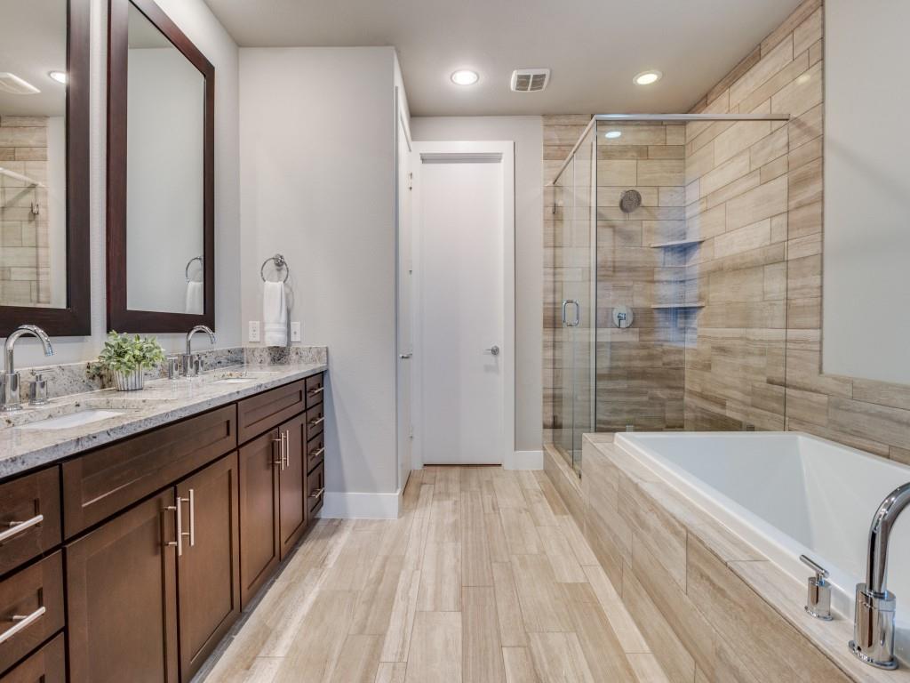 4211 Rawlins Street, Unit 97 Dallas, TX 75219 - Photo 15 of 24 a bathroom with a granite countertop sink a toilet a mirror and shower
