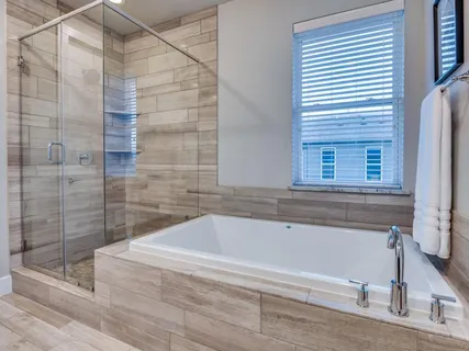 a bathroom with a bathtub and shower