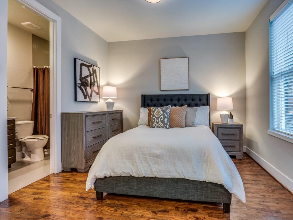 4211 Rawlins Street, Unit 97 Dallas, TX 75219 - Photo 18 of 24 a bedroom with a bed and wooden floor
