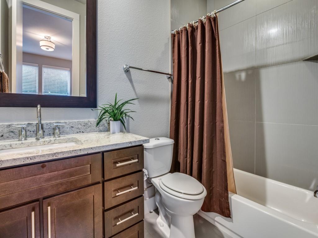 4211 Rawlins Street, Unit 97 Dallas, TX 75219 - Photo 22 of 24 a bathroom with a granite countertop sink toilet and shower