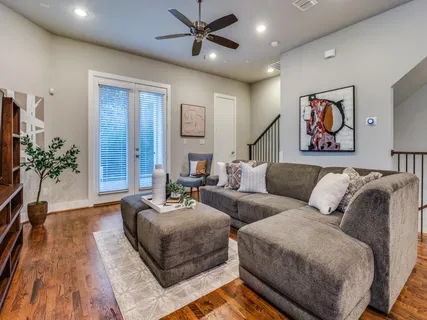 a living room with furniture and wooden floor