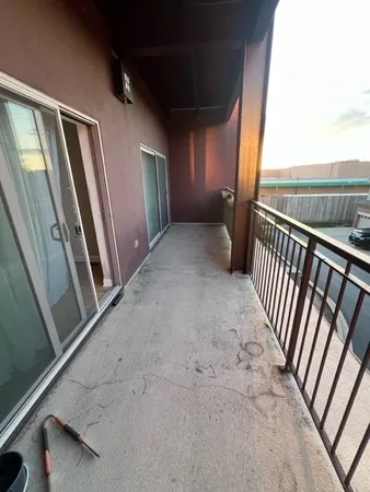a view of a livingroom with wooden floor and a flat screen tv