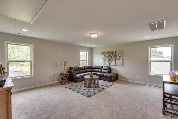 a living room with furniture window and wooden floor