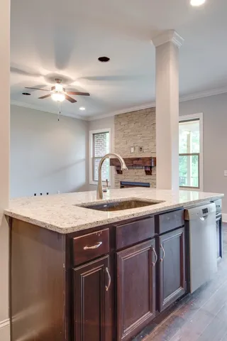 a kitchen with a sink a counter space and cabinets