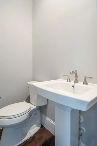 a bathroom with a sink a toilet and mirror