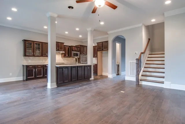 a view of kitchen and hall with wooden floor
