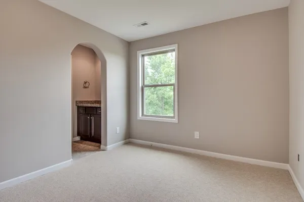 an empty room with windows and closet