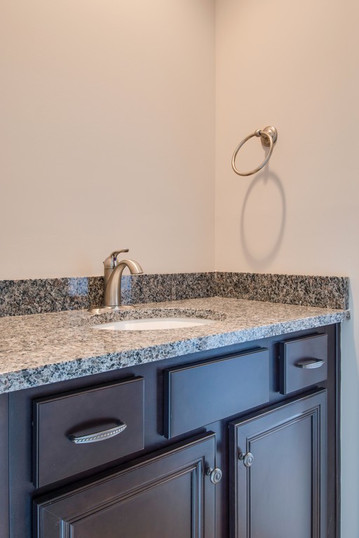 942 Hunters Lane Springfield, TN 37172 - Photo 38 of 40 a bathroom with a granite countertop sink and white cabinets
