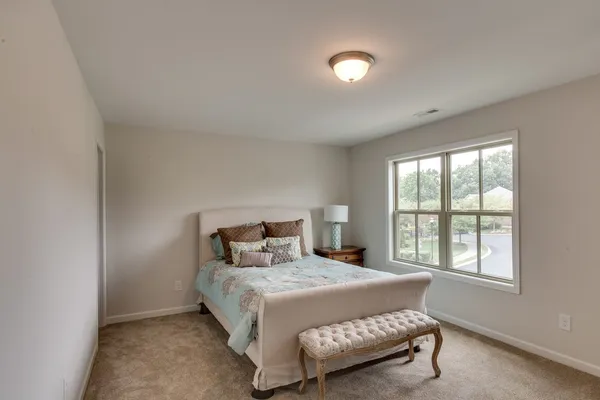 a bedroom with a bed and a window