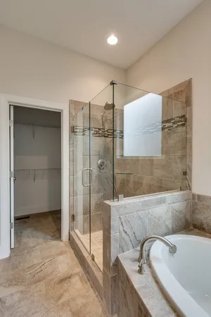 a bathroom with a tub sink and shower