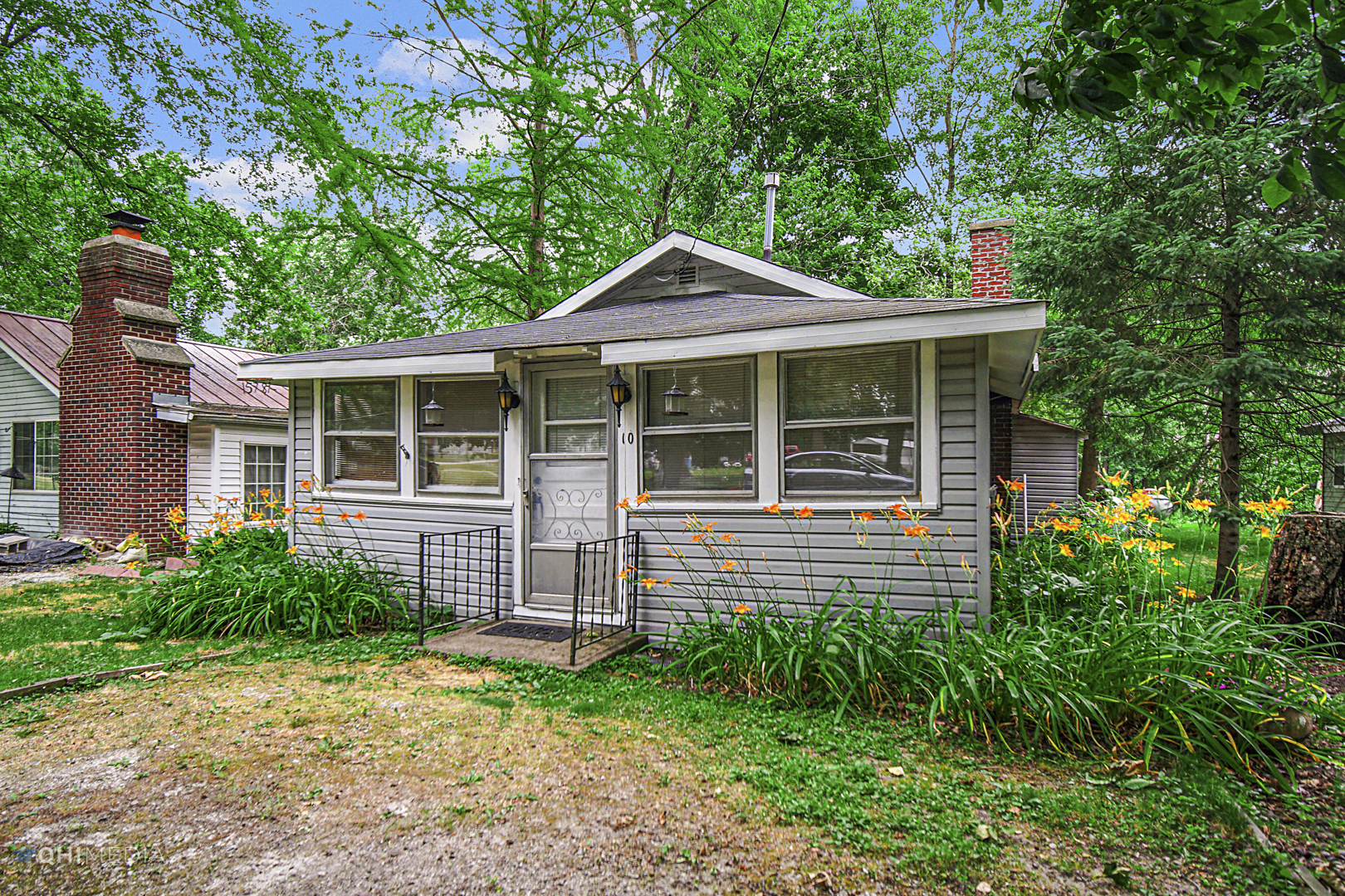 a front view of a house with a garden