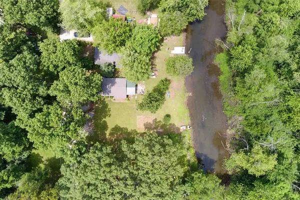 an aerial view of a house with a yard